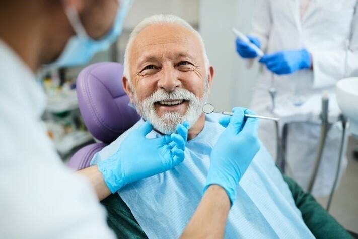 Senior man smiling during dental examination in clinic